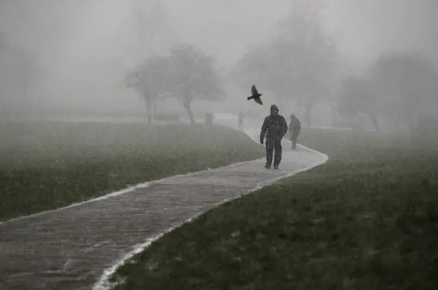 A man walks in Primrose Hill in London.