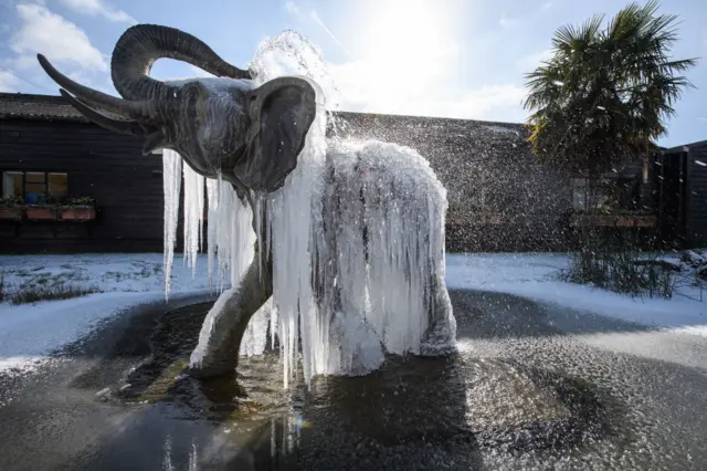 Icicles hang from a frozen elephant fountain in Colchester