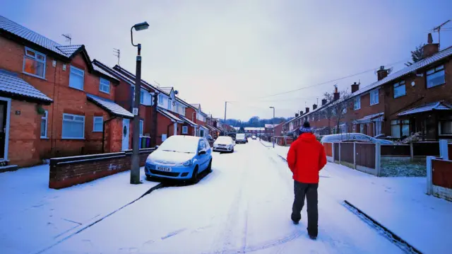 A street and car covered with snow in Liverpool.