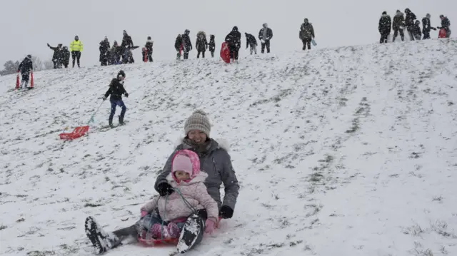 People use their sleds in the snow in Jacksons Field in Rochester.