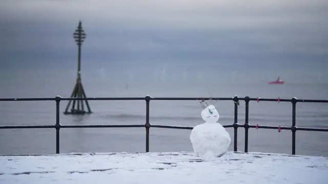 A snowman stands on the promenade at Crosby on February 27, 2018 in Liverpool,