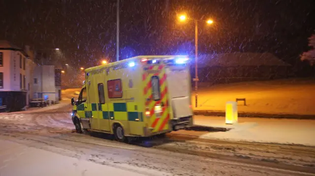 An ambulance drives through snow in Tunbridge Wells, Kent.