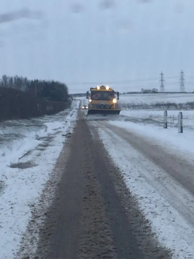 Gritter on snowy road