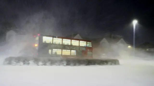 A bus travels through heavy snowfall in Whitley Bay