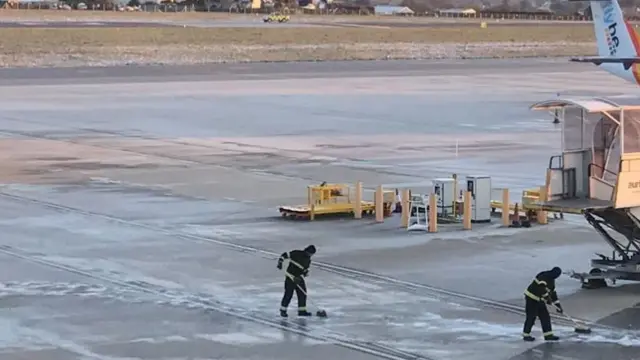 Airport runway being sweeped