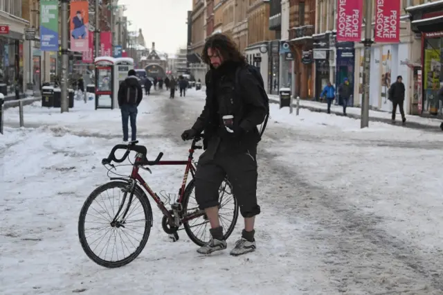 Making his way through the snow in Glasgow