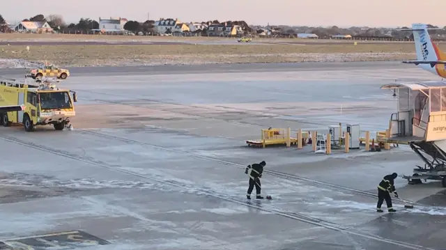 Staff clear the Guernsey Airport runway