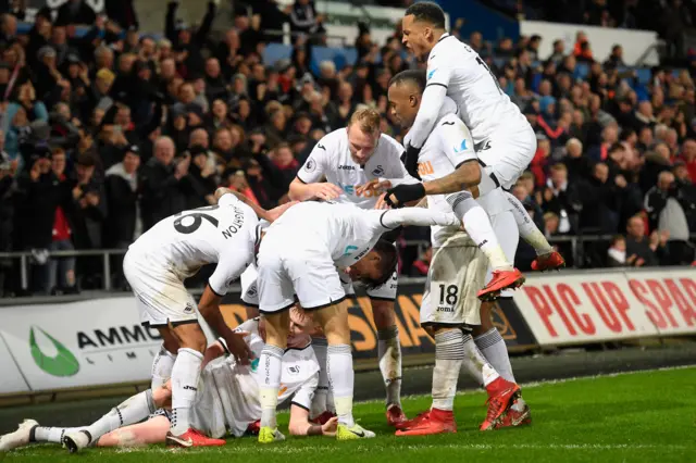 Swansea celebrating victory against Arsenal