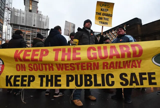 South Western rail staff with a banner picket outside Waterloo Station in London