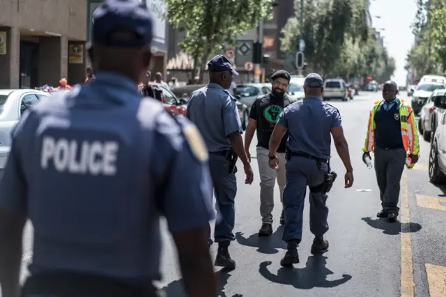 Police patrol a street outside the ANC headquarters in Johannesburg