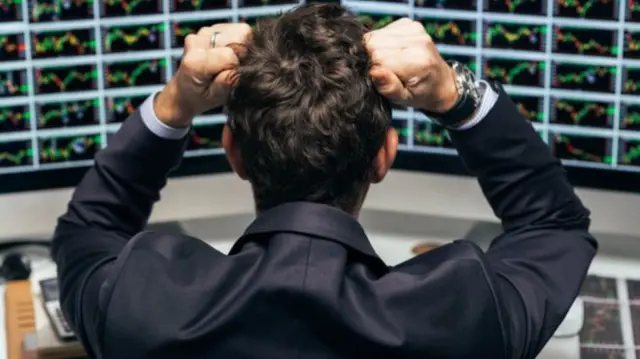 Trader holds his head