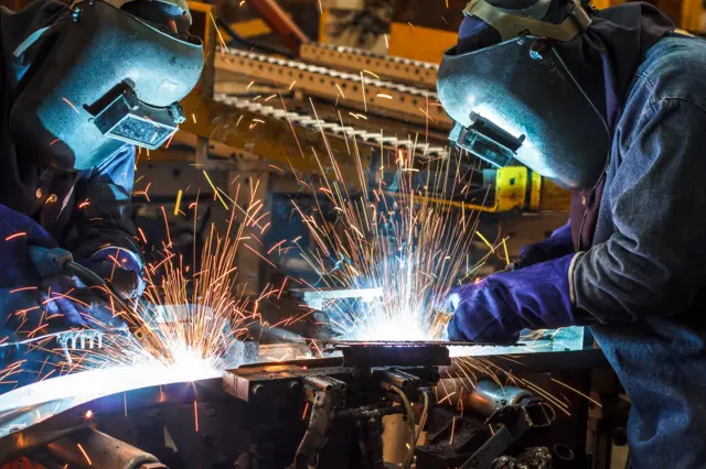 Men welding in a factory