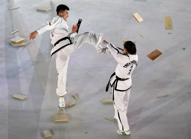 Martial artists perform ahead of the opening ceremony