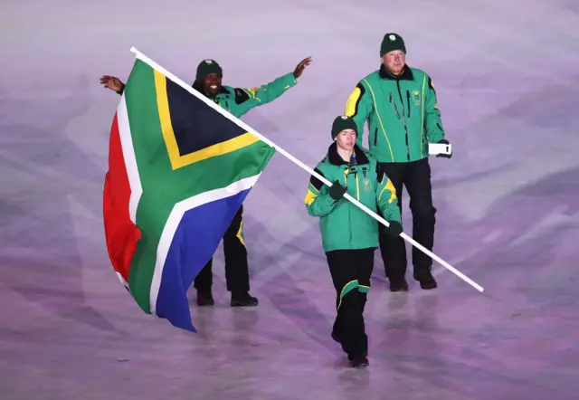 Flag bearer Connor Wilson of South Africa at the opening ceremony