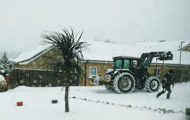 Milkman making deliveries in tractor