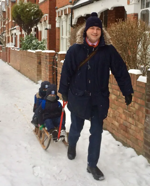 Man pulling child on sled