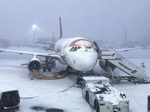 Heavy snow falls on the tarmac of the Glasgow Airport in Glasgow