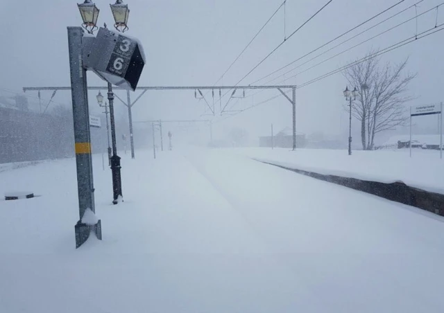 A snow-covered train station in Scotland