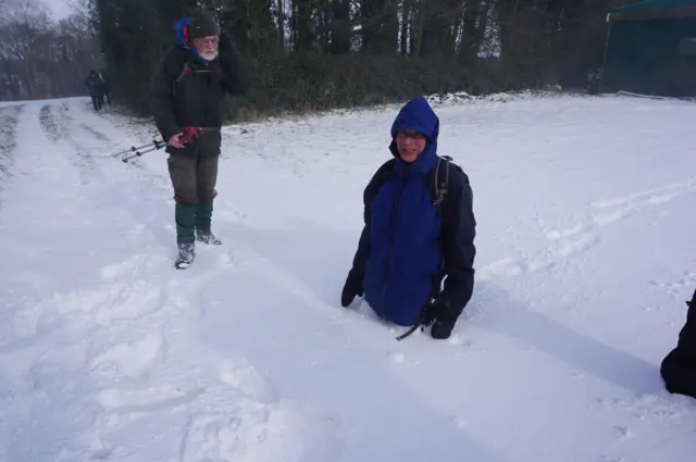 Man waist deep in snow