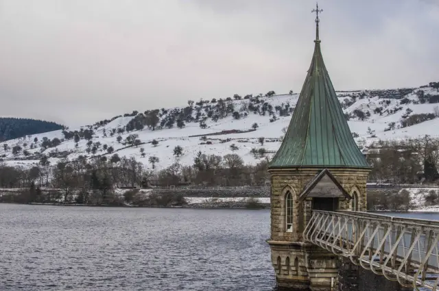 A snowy scene at a reservoir