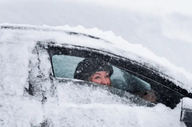 Woman window snowed under