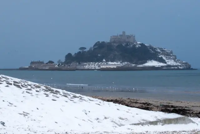 Snow still covers the beach in front of St Micheals Mount, Penzance