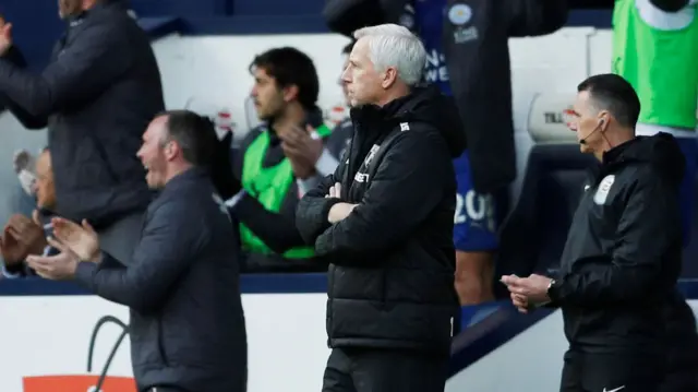 Alan Pardew looks on as the Leicester City bench celebrate