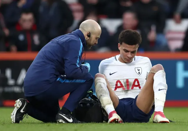 Dele Alli of Tottenham Hotspur receives treatment