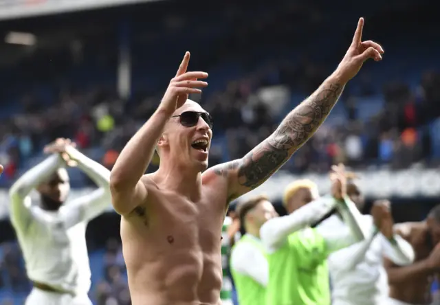 Celtic captain Scott Brown sports some dark glasses as he celebrates in the Ibrox sun