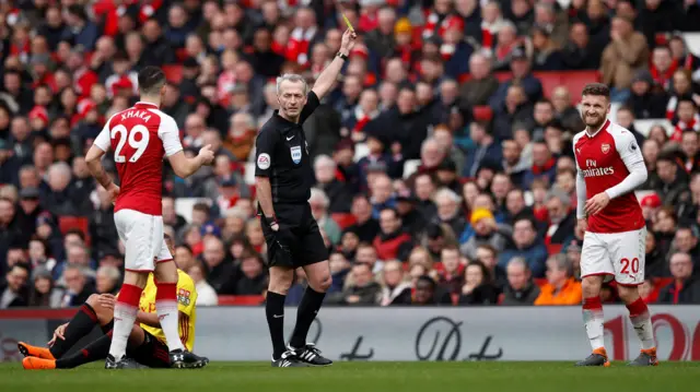 Shkodran Mustafi is shown a yellow card