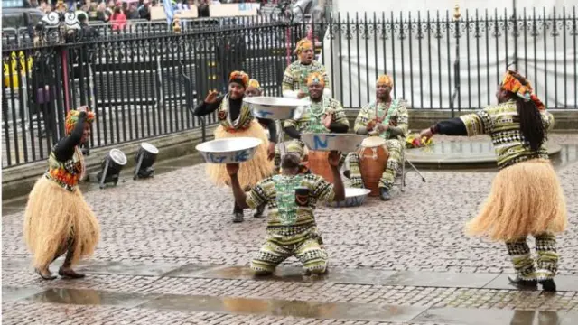 Dancers outside Westminster Abbey before the 15:00 GMT service.