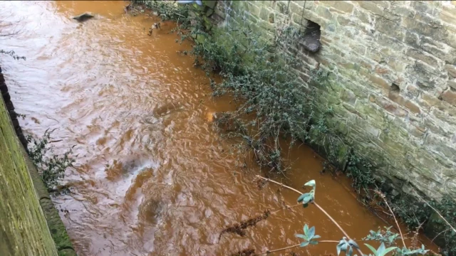 Orange coloured Porter Brook river