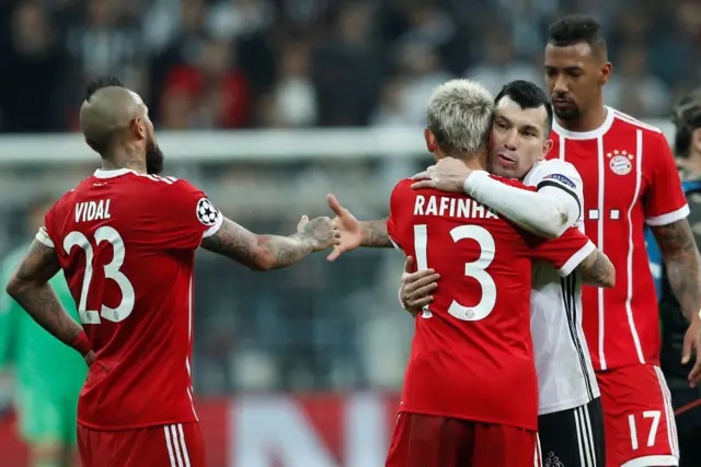 Besiktas' Gary Medel shakes hands with Bayern Munich's Arturo Vidal