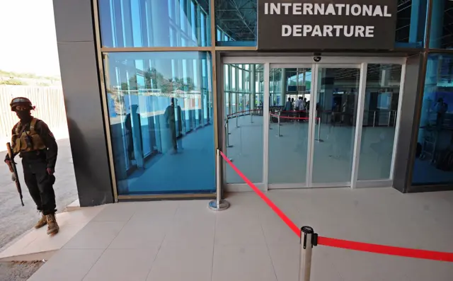 A picture taken on February 10, 2016 shows a member of the security services standing guard at Mogadishu airport. Insurgents in Mogadishu fired 'several' rounds of mortar shells targeting the Somali capital's airport, witnesses said on February 11, 2016.