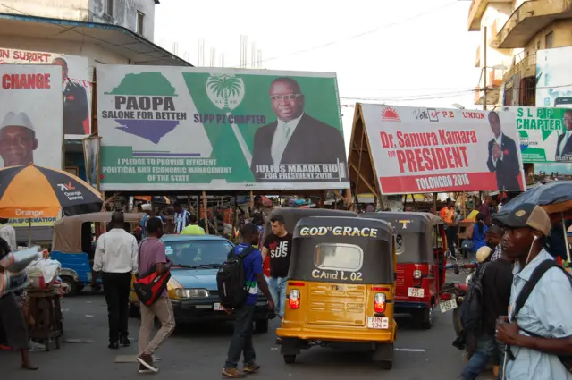 Electoral posters of the of the two presidential candidates, Julius Maada Bio and Samura Kamara who will face off during the March 27 second round of the elections are sees in central Freetown on March 12, 2018.