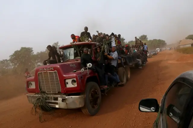 People are seen on a truck carrying the coffins of people killed by the Fulani herdsmen, in Makurdi, Nigeria January 11, 2018