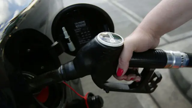 Person filling up a diesel car