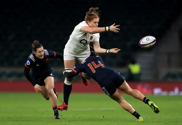 Harriet Millar-Mills of England (C) is tackled by Elodie Guiglion of France