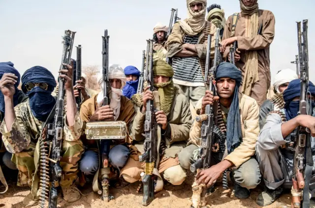 Militants of The Movement for the Salvation of Azawad listen to instructions at a waypoint while patrolling along the Mali-Niger border in the deserted area in the Meneka region in Mali during an anti jihadist patrol on February 5, 2018