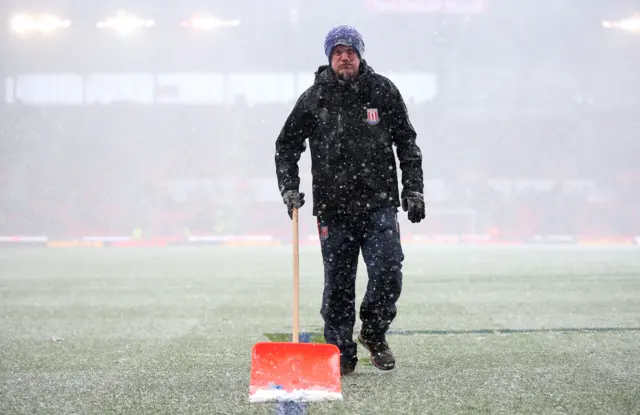 Groundsman clears the snow