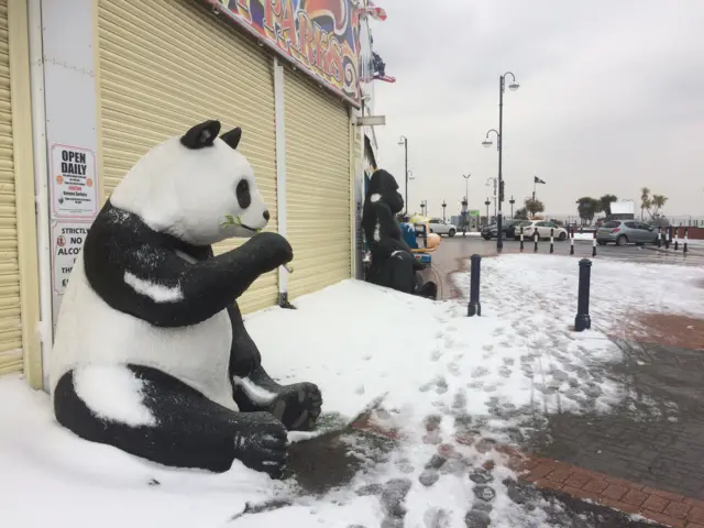 Model panda in Barry Island, surrounded by snow