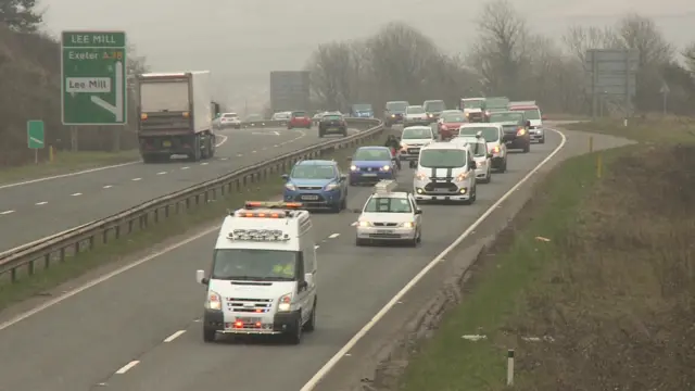 Vans in convoy on the A38