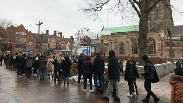 Queue of people outside Leicester Cathedral