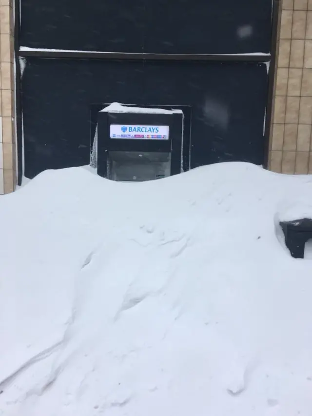 A cashpoint covered in snow