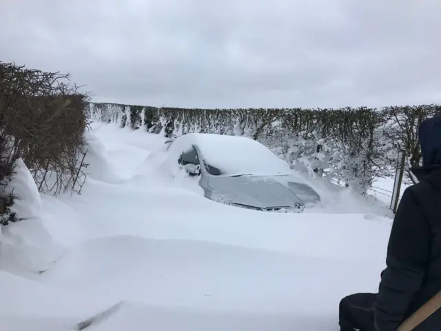 Car covered in snow in Drumbo