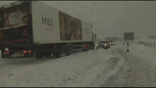 Lorry and cars in snow