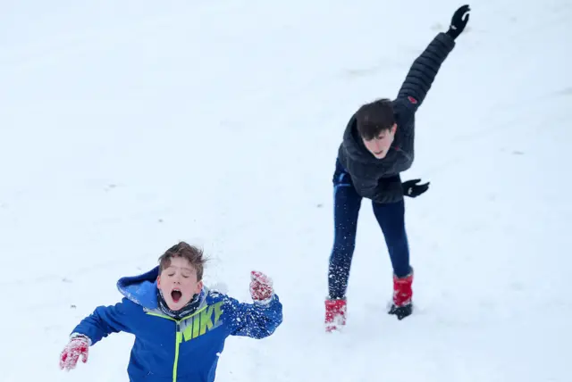 Boys throwing snowballs at each other