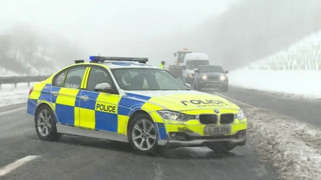 Police car and traffic on a snowy road