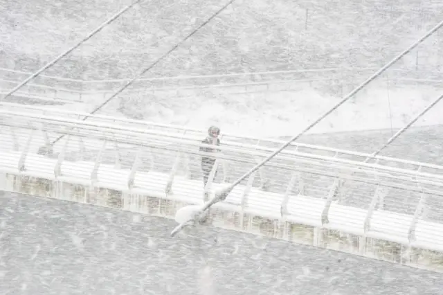 Laura Witham walking over the foot bridge near Ranelagh Road