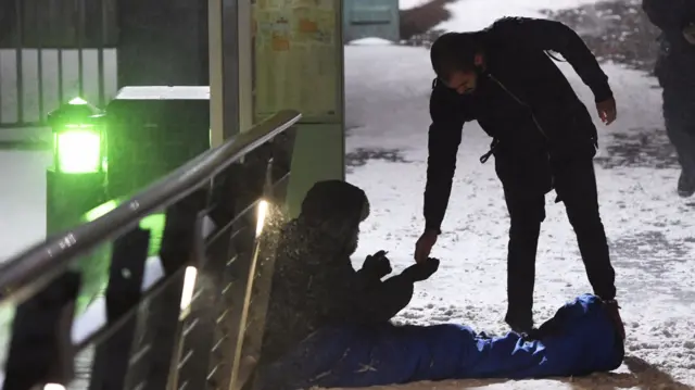 A man offers help to a rough sleeper in Birmingham